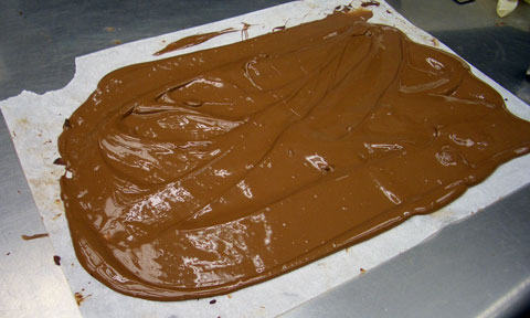 The chocolate left over after candy bars are dipped is cleverly reused. Wanat pours it on parchment paper, lets it set as a slab, then chops it up and melts it again.