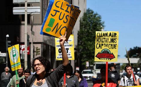 Demonstrators in San Francisco march in the streets in protest against delays to the climate and energy bill that is currently awaiting a crucial Senate vote. Dozens of protesters from the group Mobilisation for Climate Justice held a demonstration outside of the offices of Chevron and US Senator Barbara Boxer. Photo: Justin Sullivan/Getty Images North America.