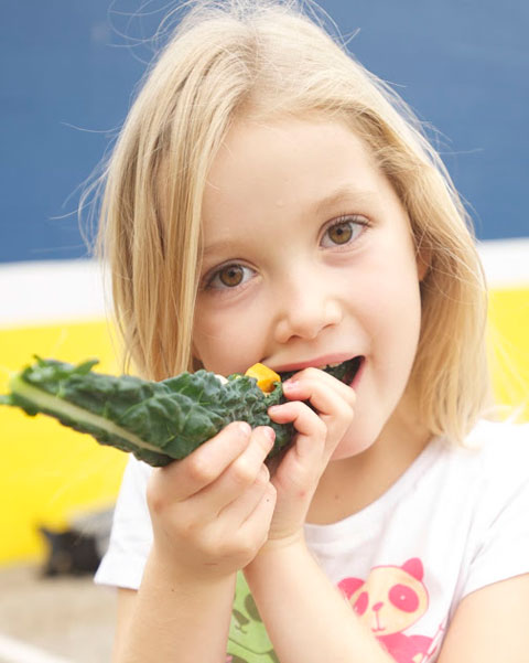 Meiners Oaks Elementary School student enjoying a raw kale taco.